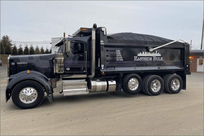 A black Eastside Bulk tri-axle dump truck