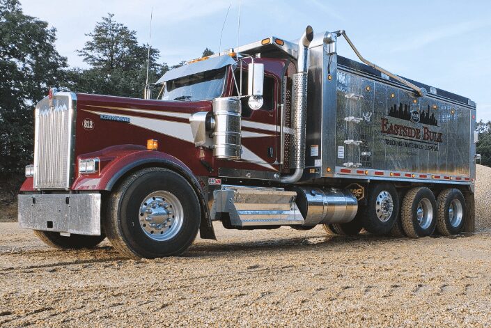 A maroon Eastside Bulk tri-axle dump truck