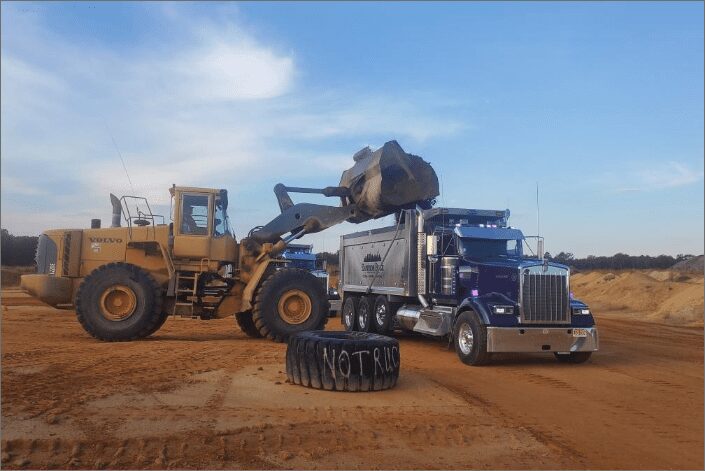 A wheel loader loading an Eastside Bulk truck